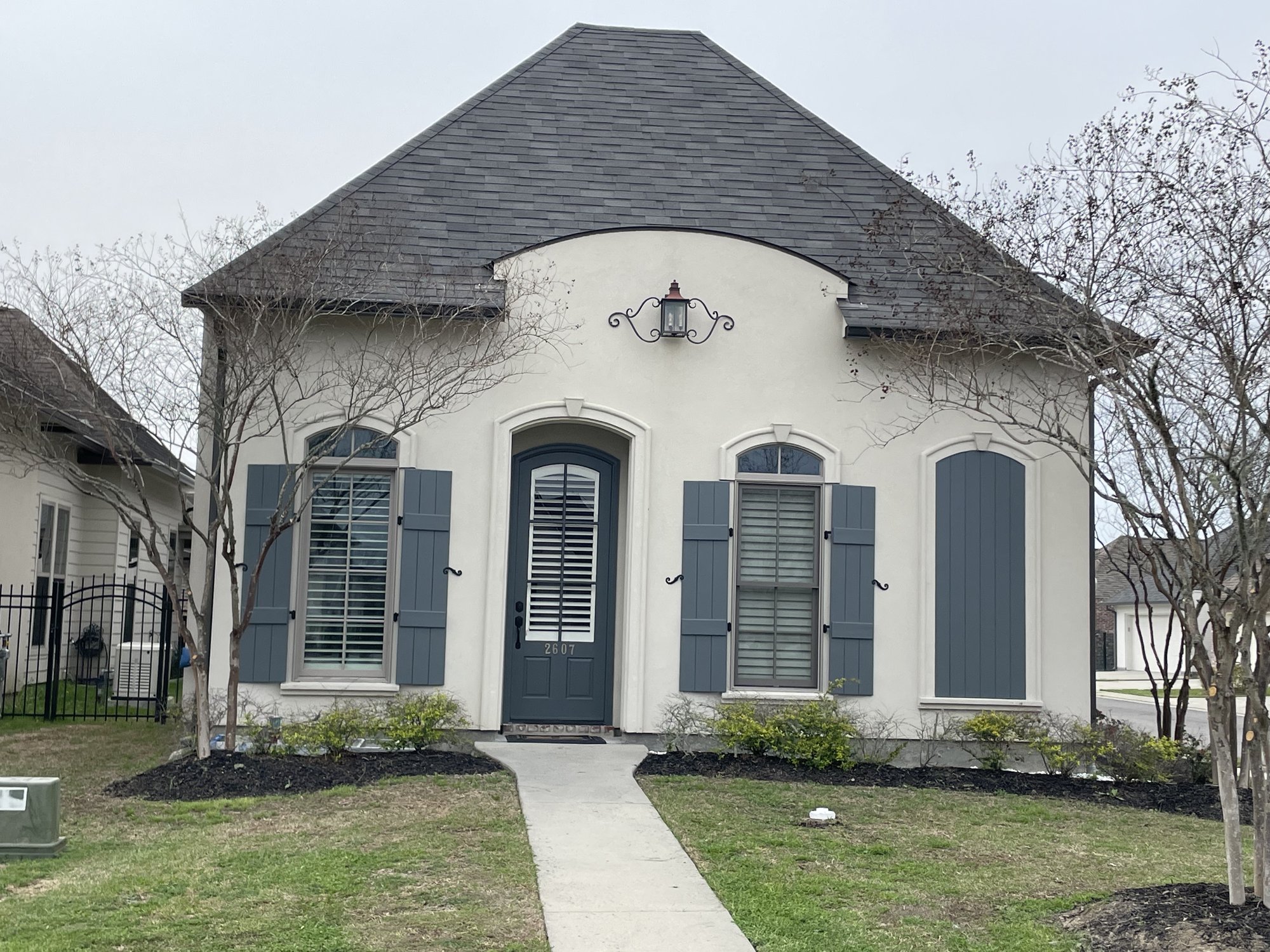 French-Acadian home — exterior with custom shutters and arched entry