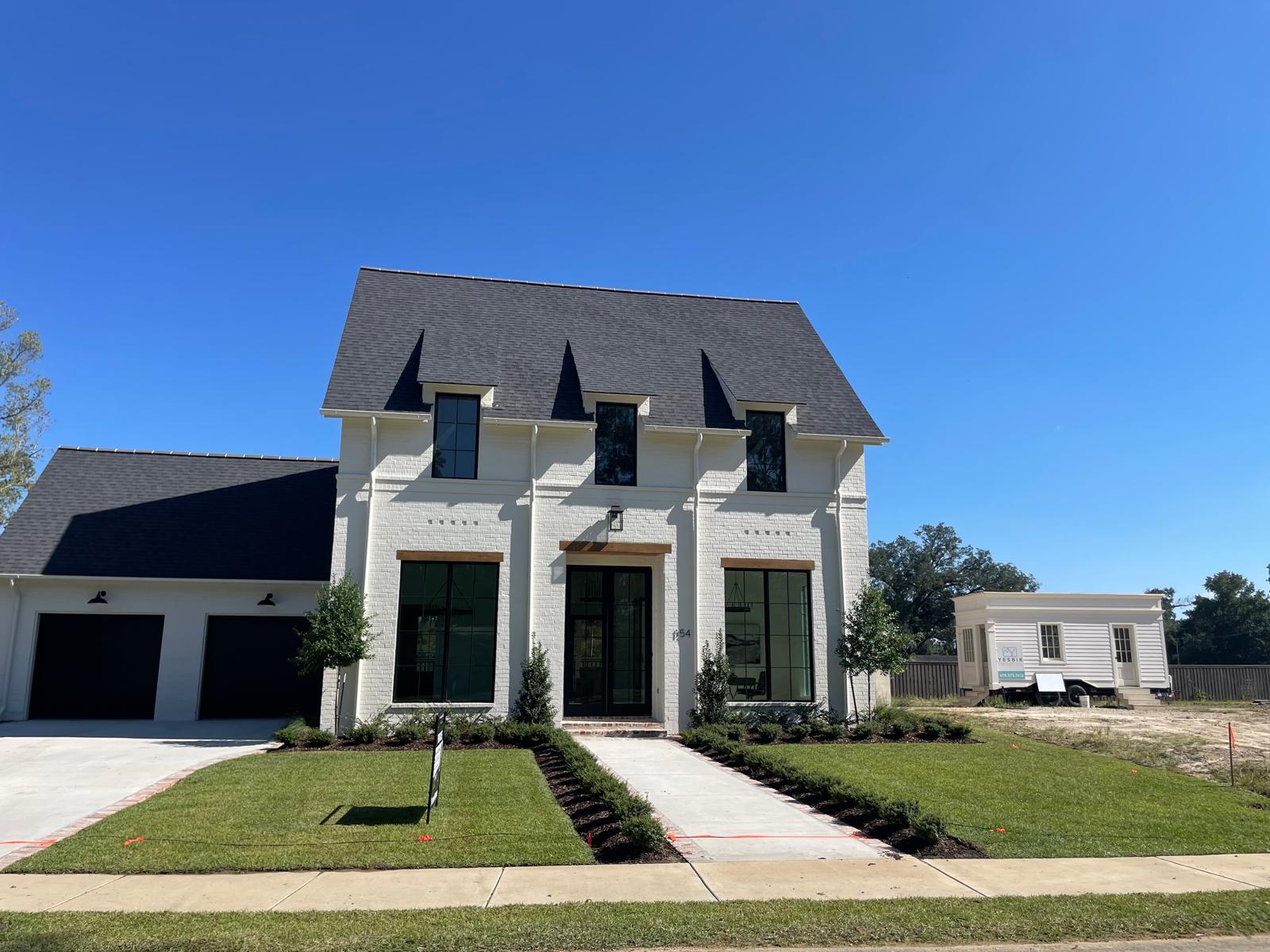 White-brick modern two-story — finished exterior